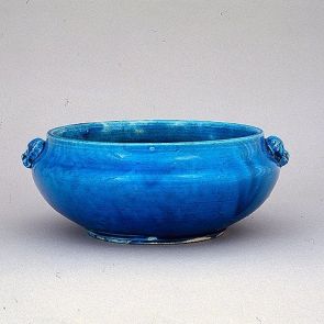 Bulbous bowl decorated with an animal's head mask