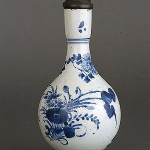 Bottle vase with metal lid and floral design