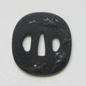Tsuba with three slots, decorated with two figures in a riverside landscape