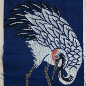 Textile sample - silver-white crane with yellow legs against a dark blue background