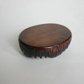 Oval, wooden stand for a vase