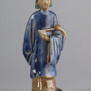 Standing female figure with a fly-whisk