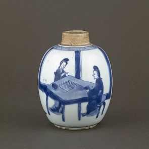 Egg-shaped teaholder, decorated with a scene depicting ladies playing a table game