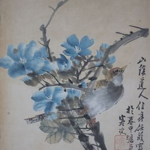 Bird on a branch of blue flower